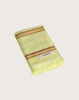Købn Citrus Hand Towel featuring raw edge fringing folded