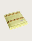 Købn Citrus Towel featuring raw edge fringing folded