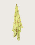 Købn Citrus Towel stripes and raw edge fringing hanging on a hook
