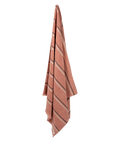 Striped towel with a terracotta base and black and cream stripe on a white background