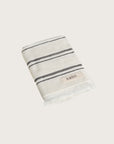 Købn Crema Hand Towel featuring raw edge fringing folded