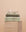 Matcha bathroom set folded on a travertine plinth with a clam shell on top.