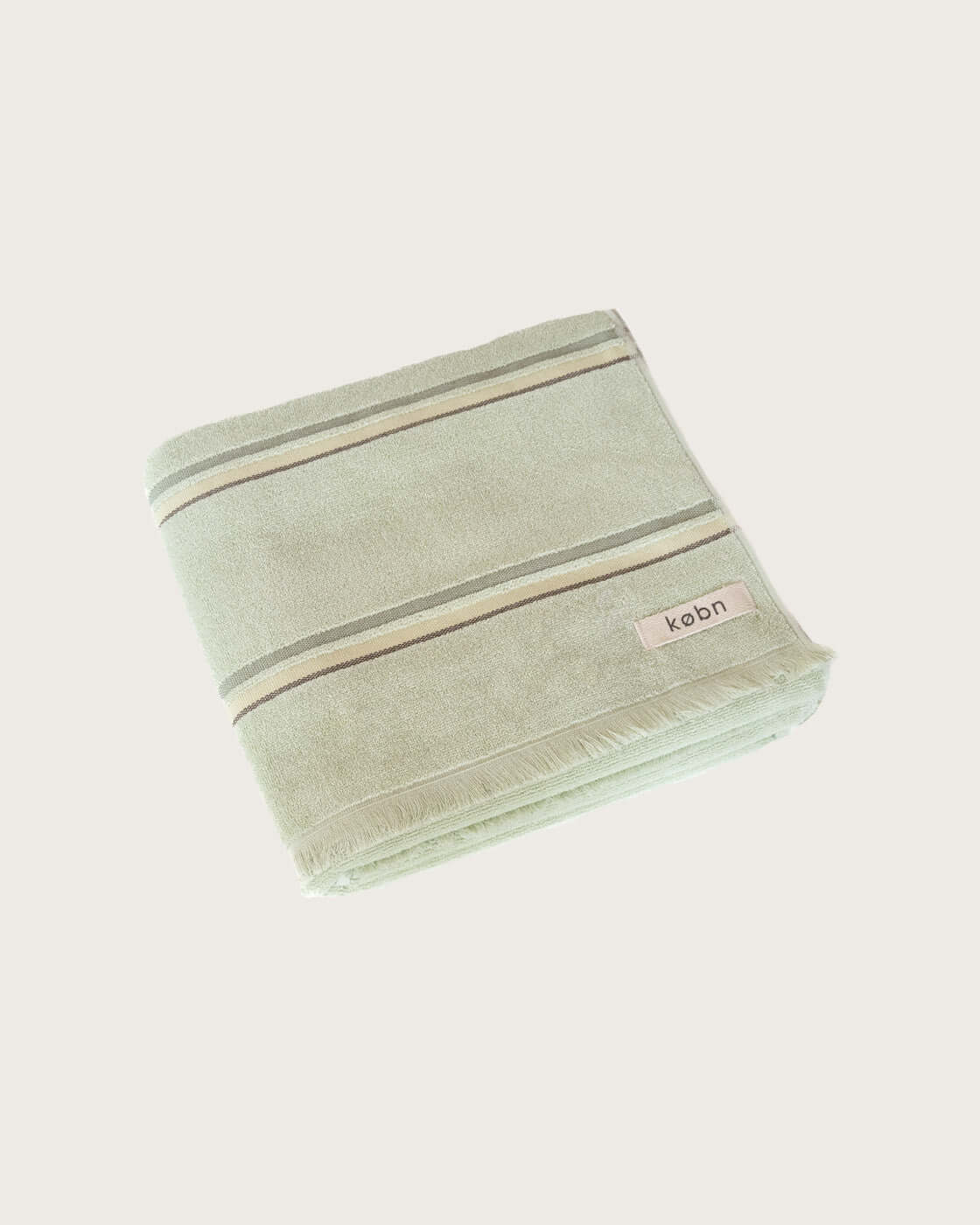 Light Green towel with multi coloured stripe folded on a white background