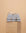 Stack of Mist Bathroom towels , hand towel and bathmat folded on a travertine plinth.