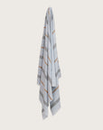 Købn Mist Towel with stripes and raw edge fringing hanging on a hook