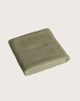 Købn Olive Bathmat folded with a plush pile chunky cotton weave