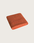 Købn Tamarillo Bathmat folded with a plush pile chunky cotton weave. Sustainably made in Turkey.