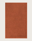 Rectangular orange bathmat on a light beige background