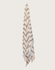 Kobn Crema towel with black stripes hanging on a butter yellow background