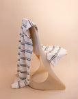 Kobn Crema striped towel draped on a chair