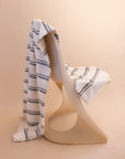 Kobn Crema striped towel draped on a chair