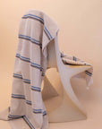 Kobn striped Ecru towel draped on a chair