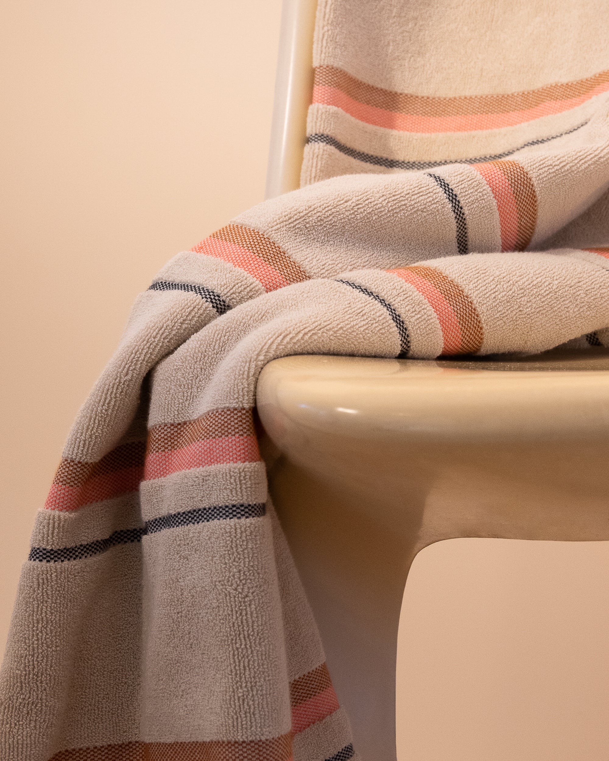 Kobn Sand towel draped on a chair