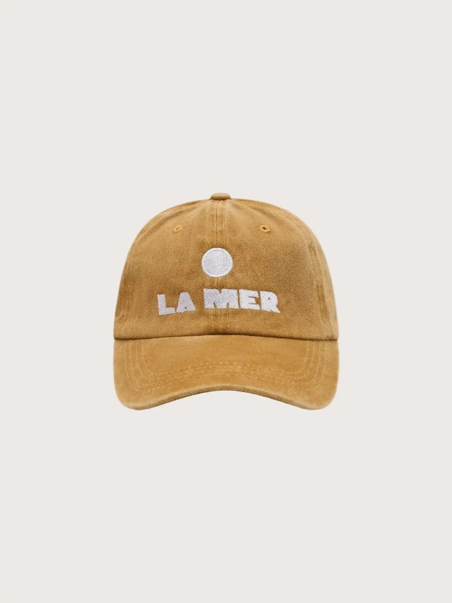 Soft cotton stonewash cap n Mustard with La Mer embroidered text on front.