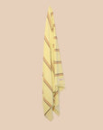 Bright Citrus Turkish towel with stripes and fringing by kobn hanging on a butter yellow background