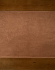 Dussty Pink bath mat on a wooden floor