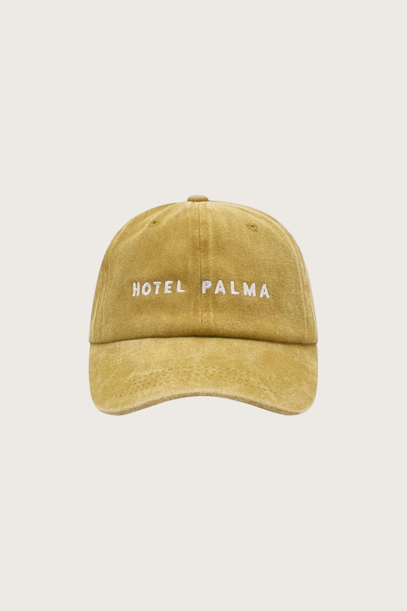 Embroidered cap with the words Hotel Palma on the front in a stonewash cotton in Mustard