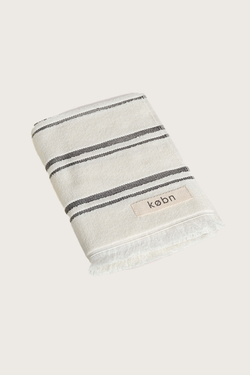 Købn Crema Hand Towel featuring raw edge fringing folded 