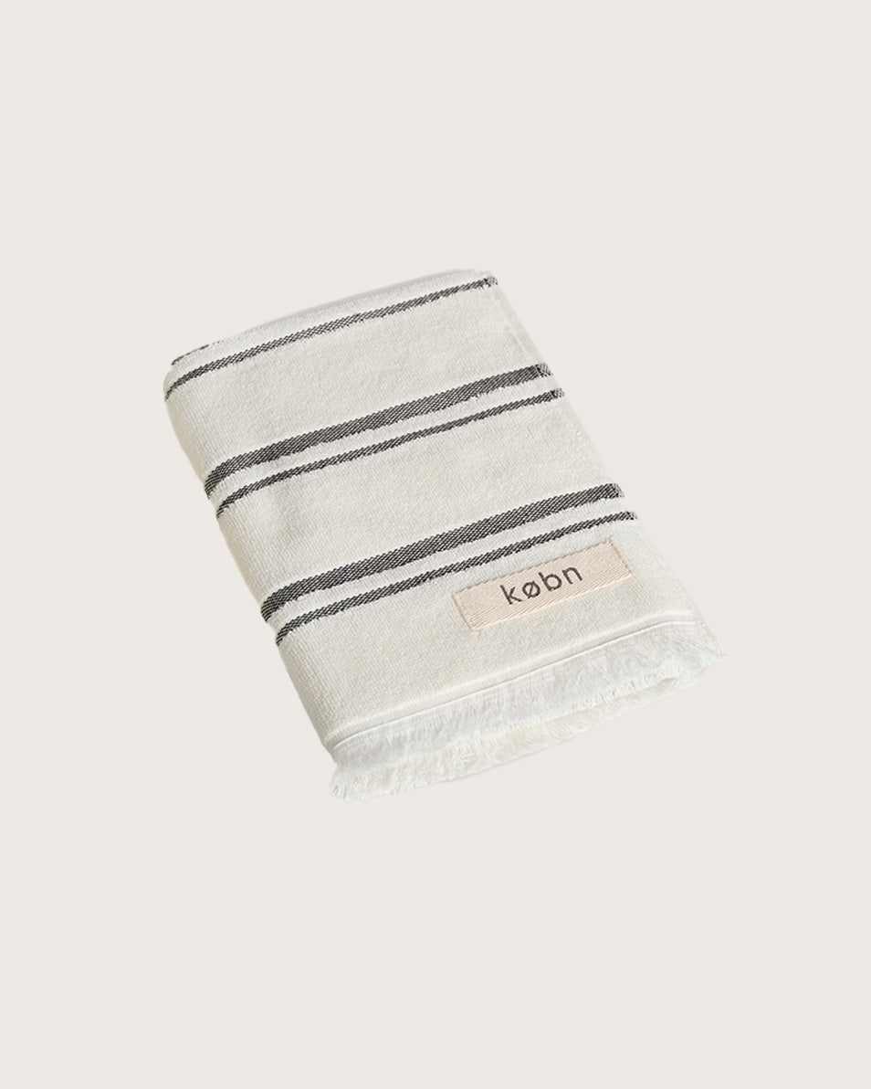 Købn Crema Hand Towel featuring raw edge fringing folded 