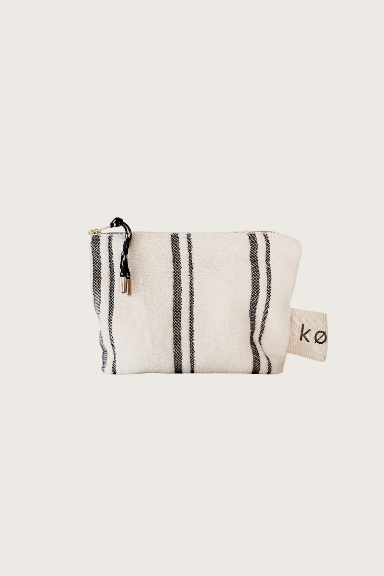 Small Kobn towelling pouch in Crema with black stripes and featured zip pull. 