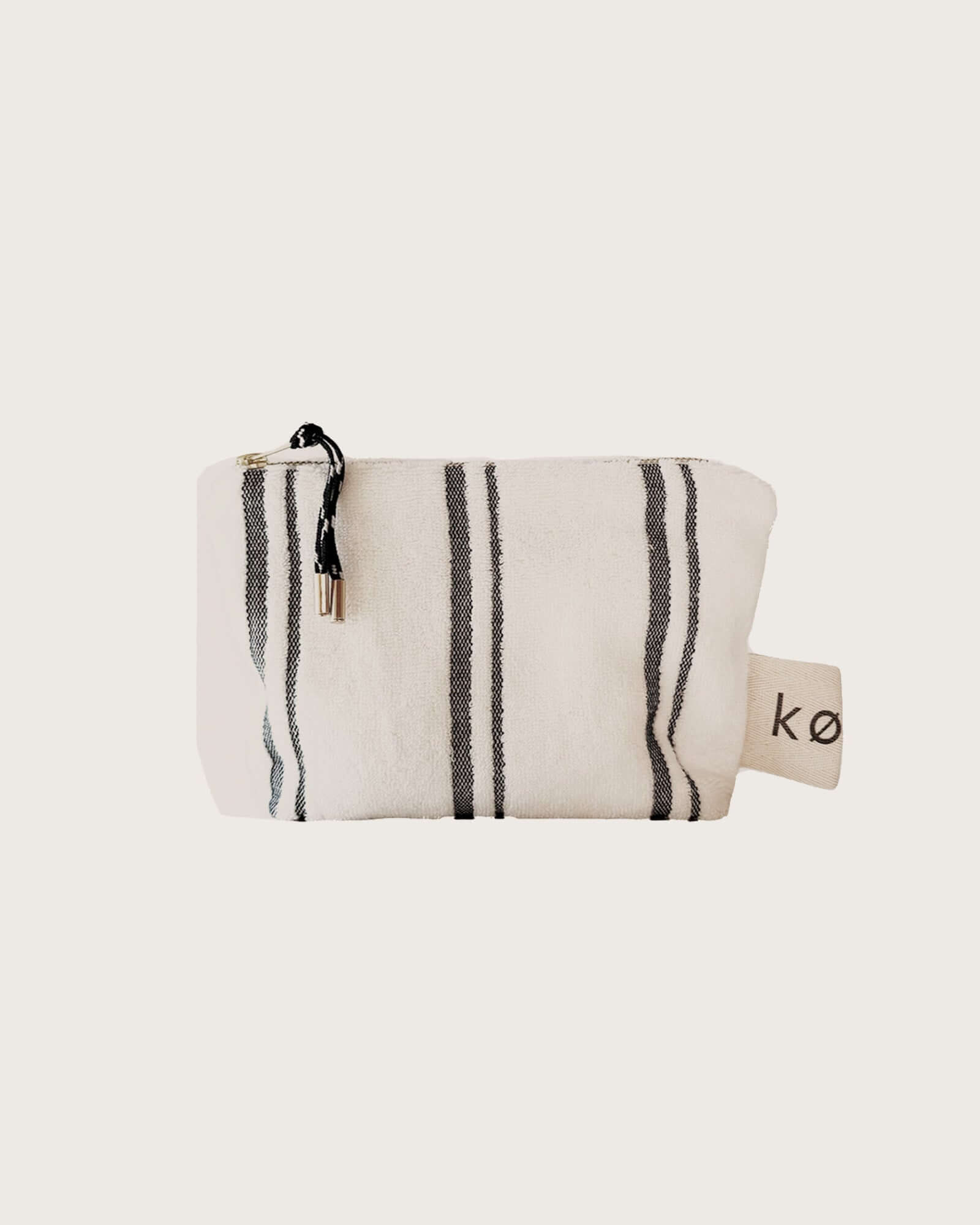 Small Kobn towelling pouch in Crema with black stripes and featured zip pull. 