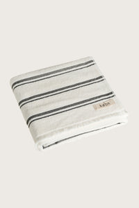 Købn Crema Towel featuring raw edge fringing folded 