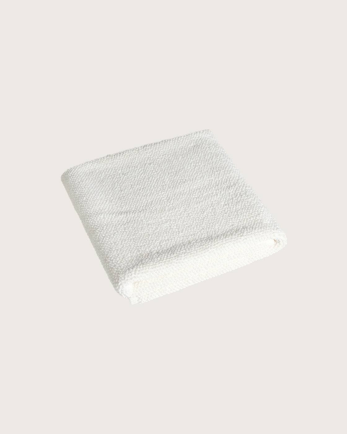 Købn Crema Bathmat folded with a plush pile chunky cotton weave