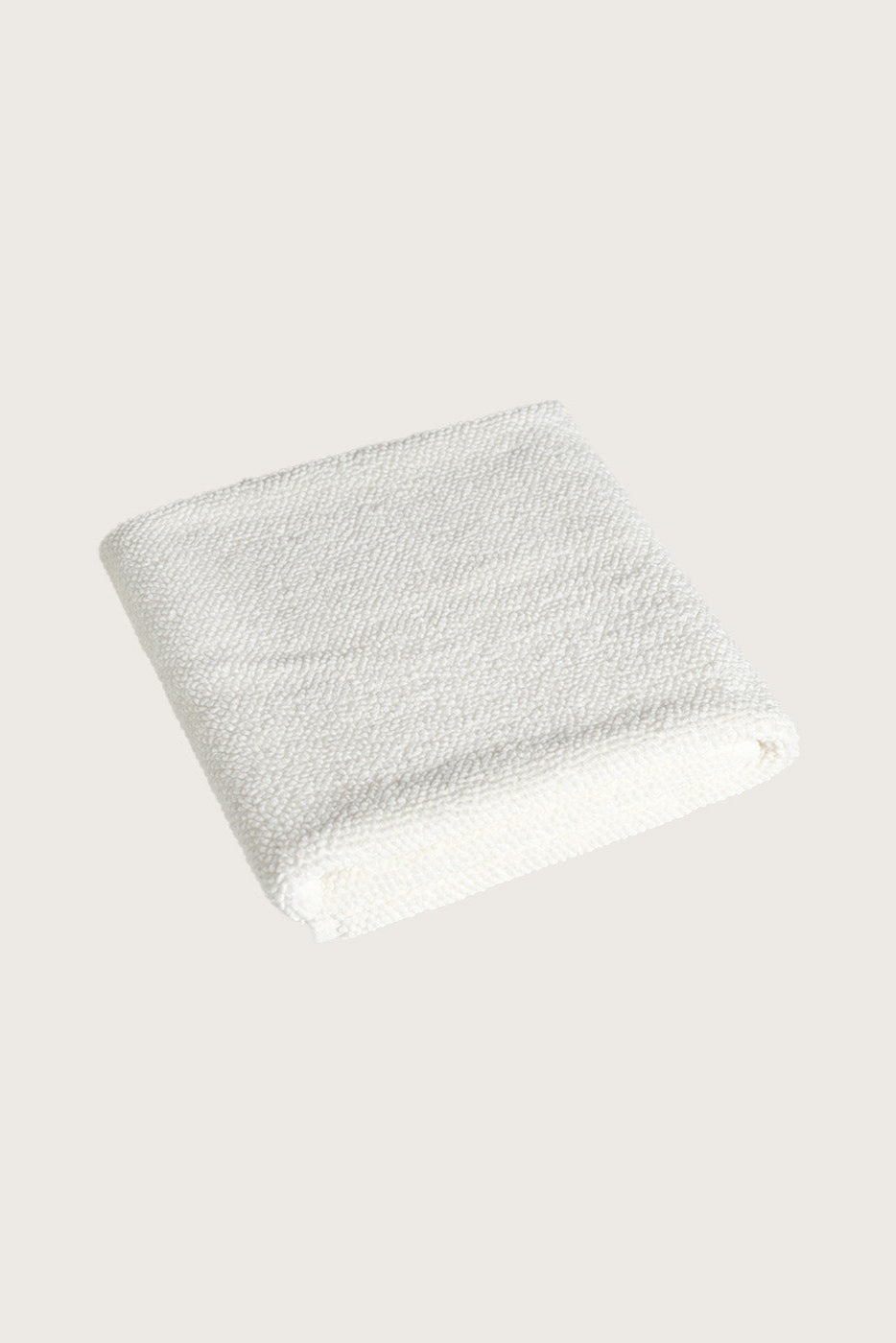 Købn Crema Bathmat folded with a plush pile chunky cotton weave