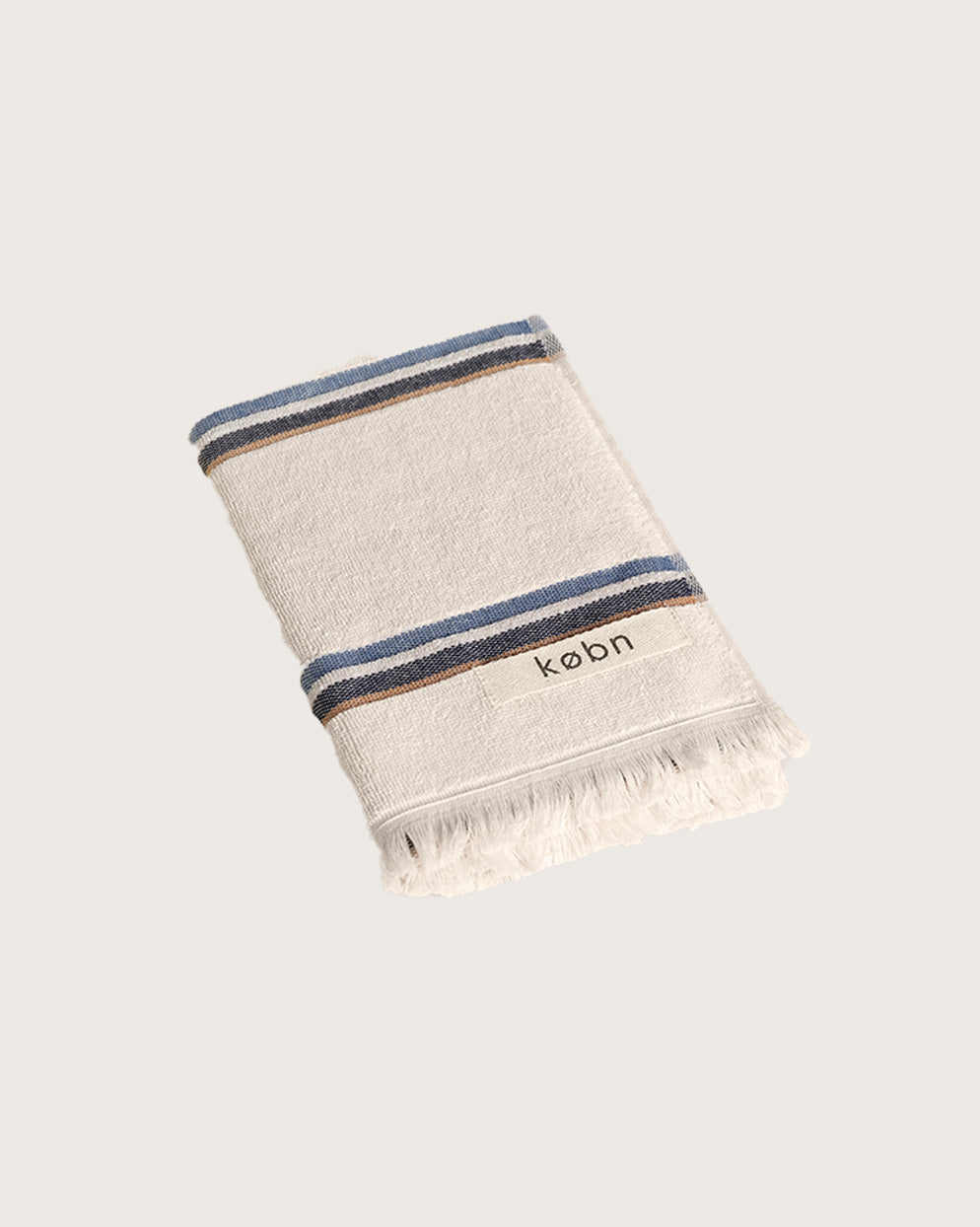 Købn Ecru Hand Towel featuring raw edge fringing folded 