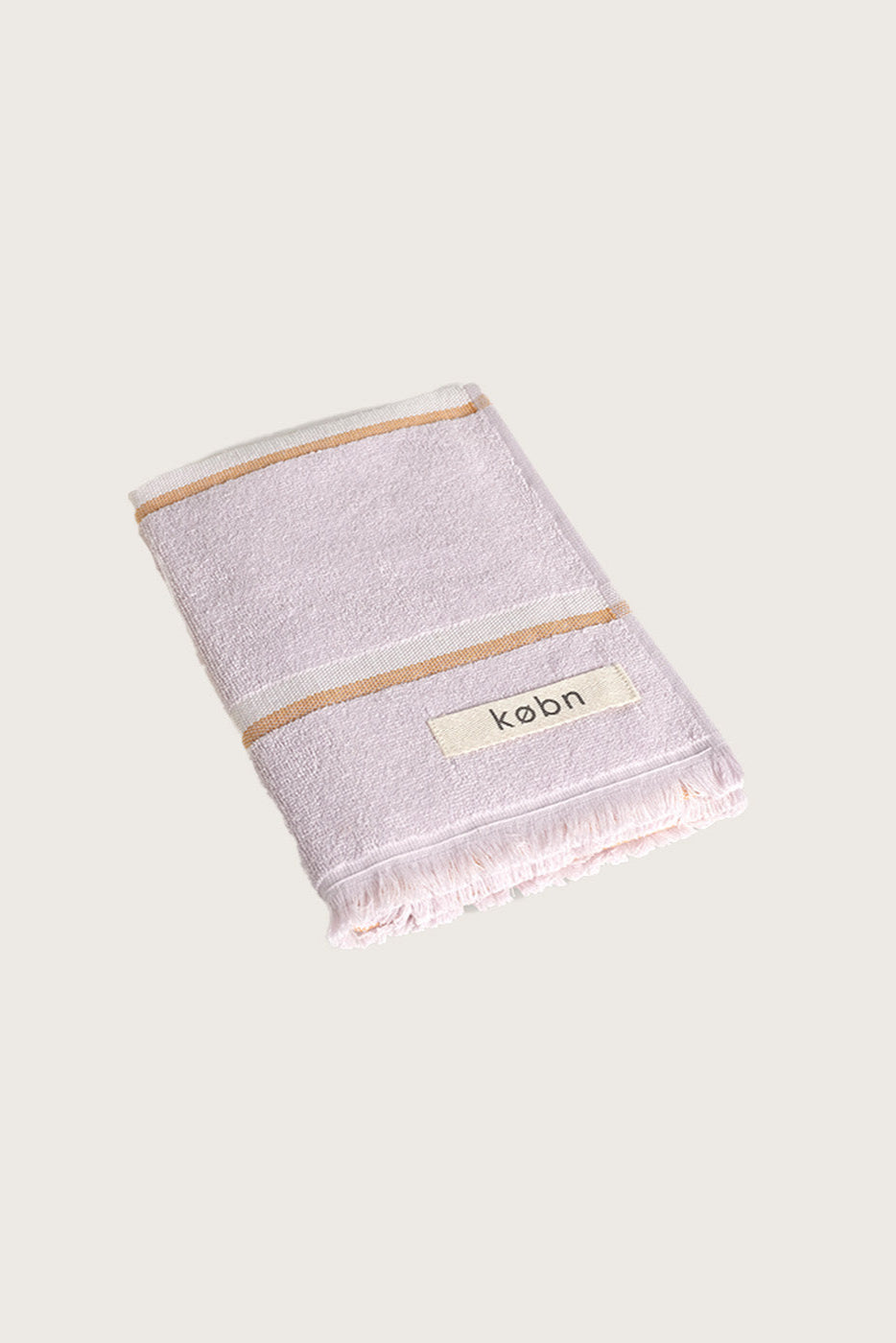 Købn Lilac Hand Towel featuring raw edge fringing folded 