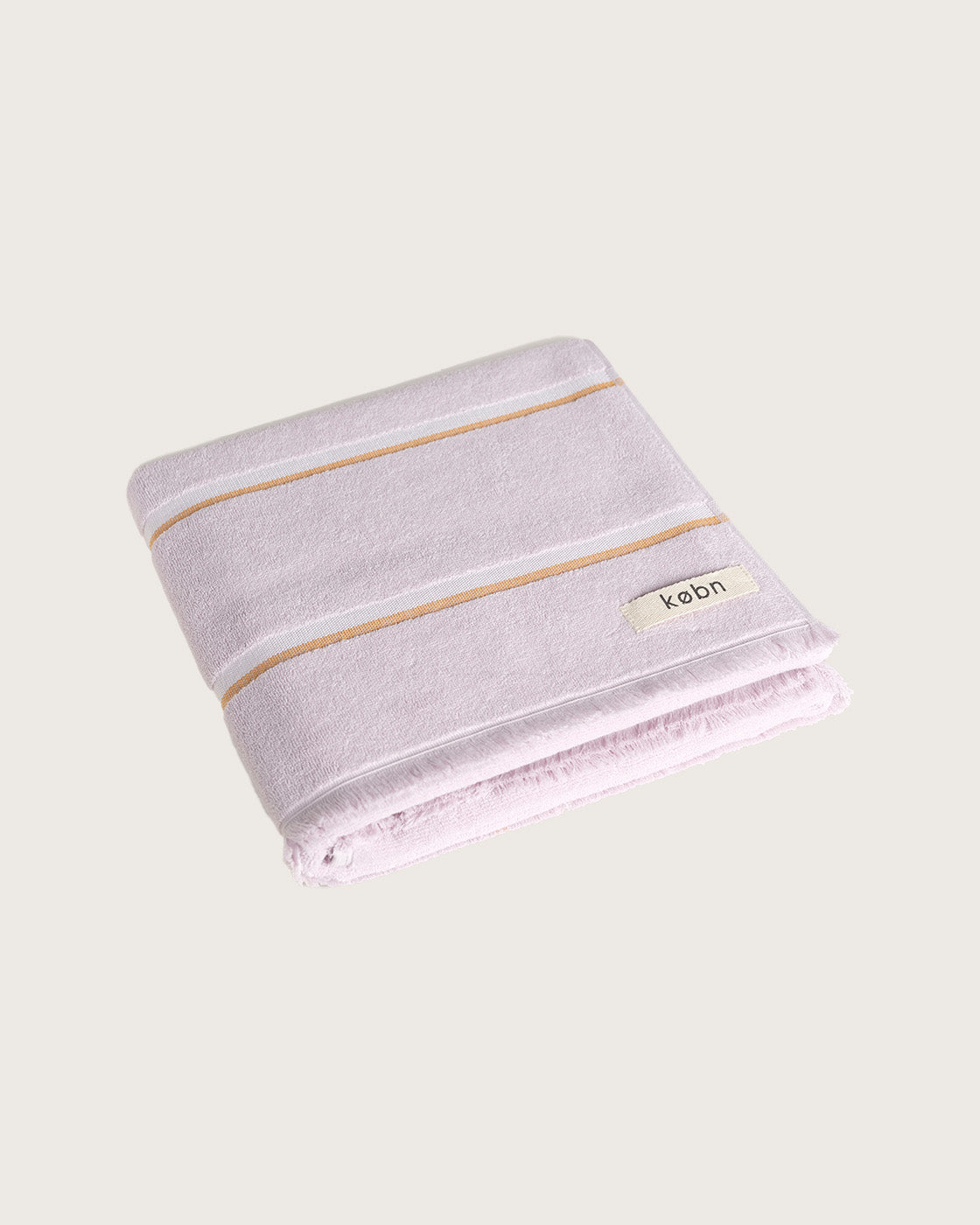 Købn Lilac Towel featuring raw edge fringing folded 