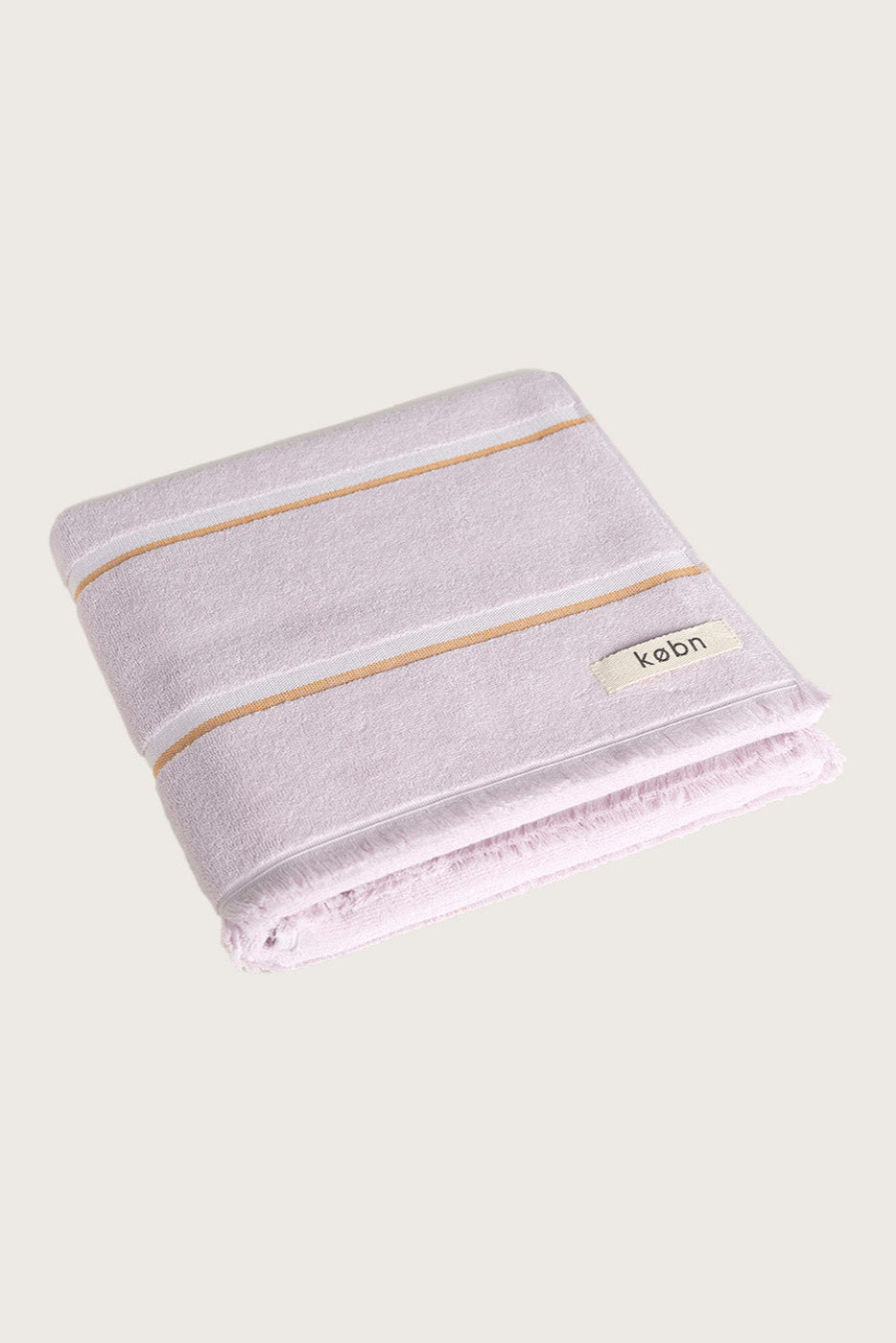 Købn Lilac Towel featuring raw edge fringing folded 