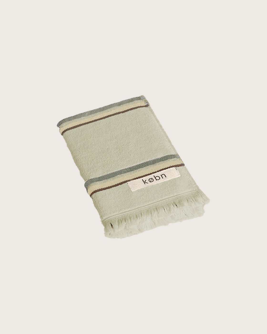 Købn Matcha Hand Towel featuring raw edge fringing folded 