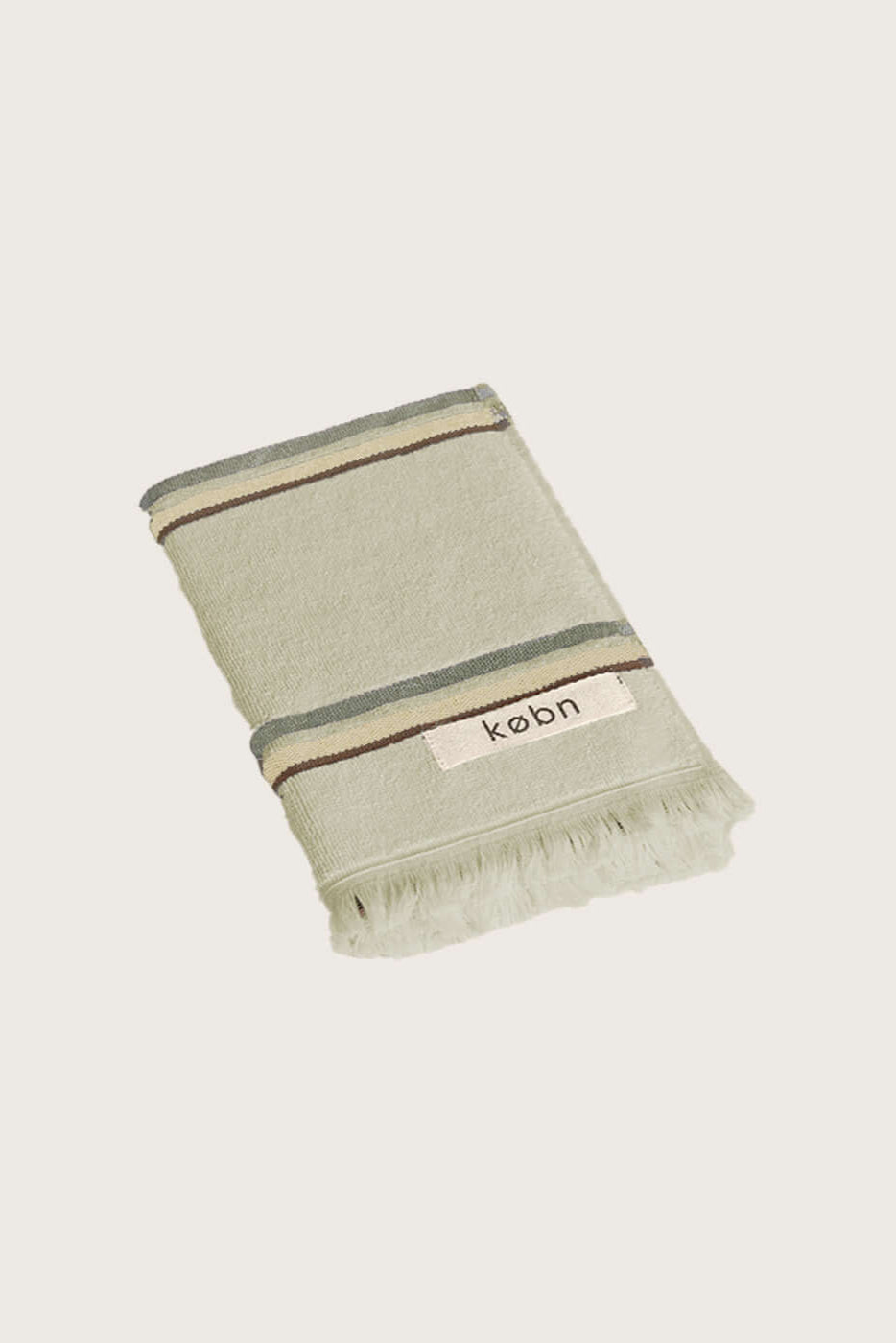 Købn Matcha Hand Towel featuring raw edge fringing folded 