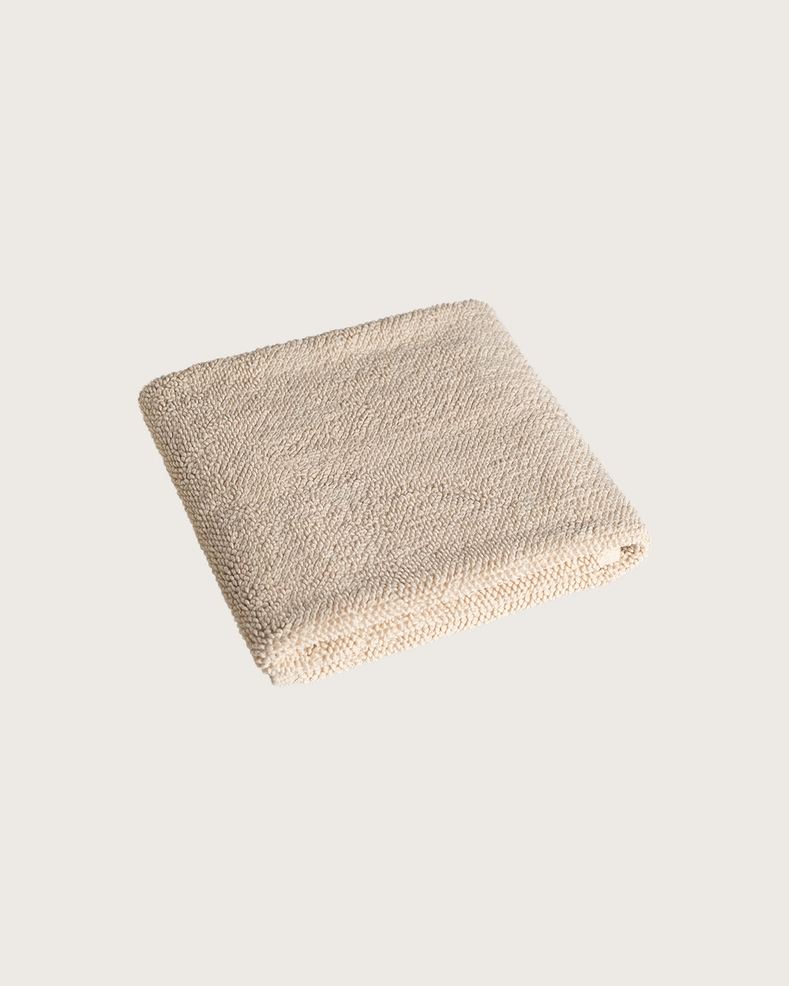 Købn Sand Bathmat folded with a plush pile chunky cotton weave