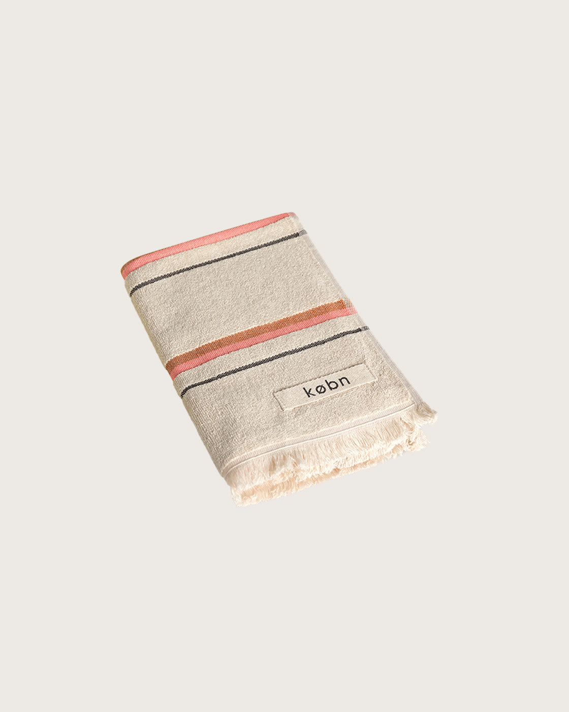 Købn Sand Hand Towel featuring raw edge fringing folded 