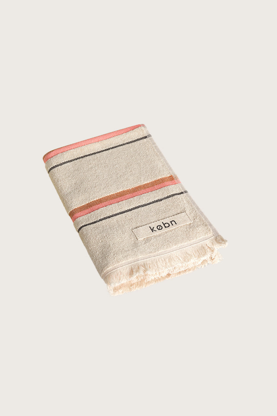 Købn Sand Hand Towel featuring raw edge fringing folded 