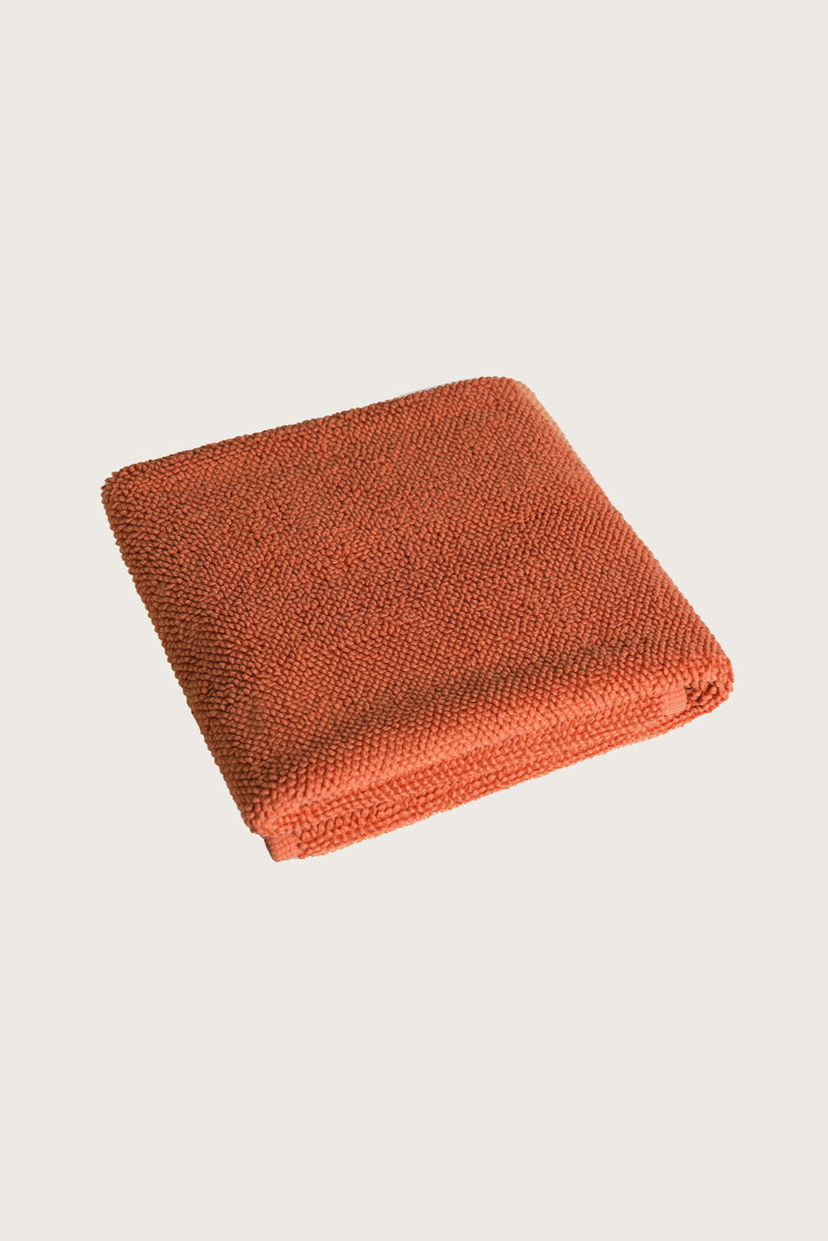 Købn Tamarillo Bathmat folded with a plush pile chunky cotton weave. Sustainably made in Turkey. 