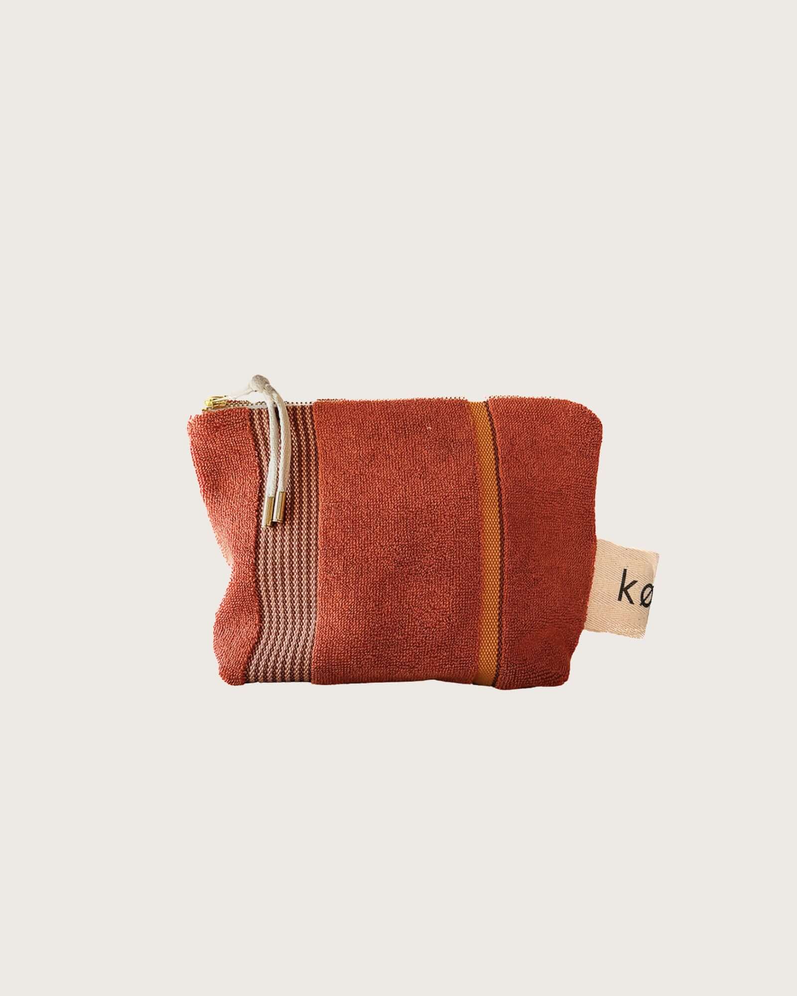 Kobn Tamarillo Towelling pouch with stripes and gold zip with cream zip pull. 