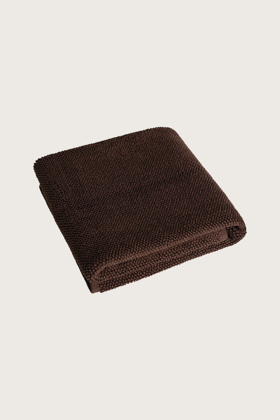 Købn Umber Bathmat folded with a plush pile chunky cotton weave