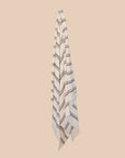 Kobn Crema towel with black stripes hanging on a butter yellow background