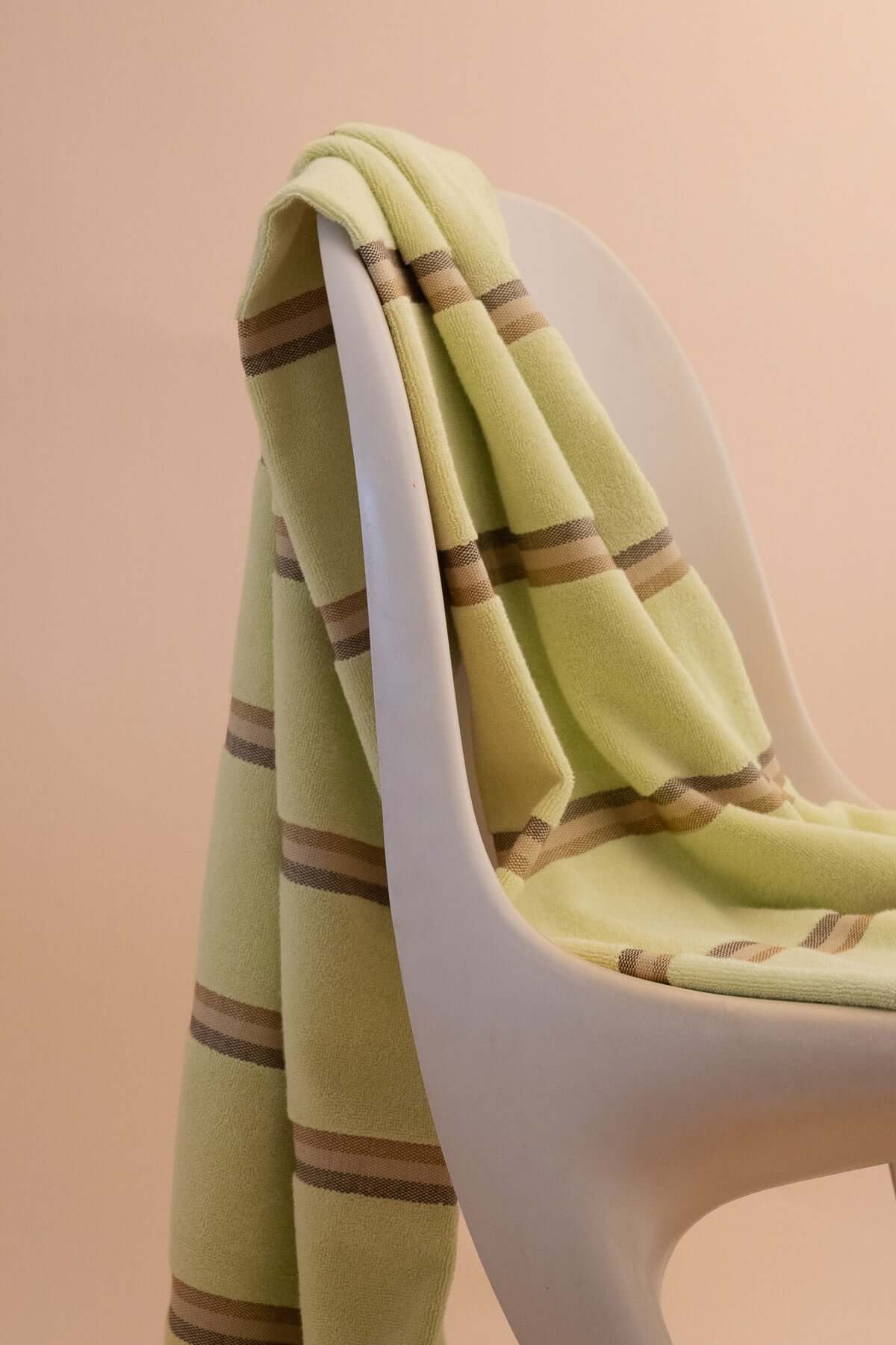 Elevated Citrus towel  by kobn with brown stripes  on an original Casala Dining Chair