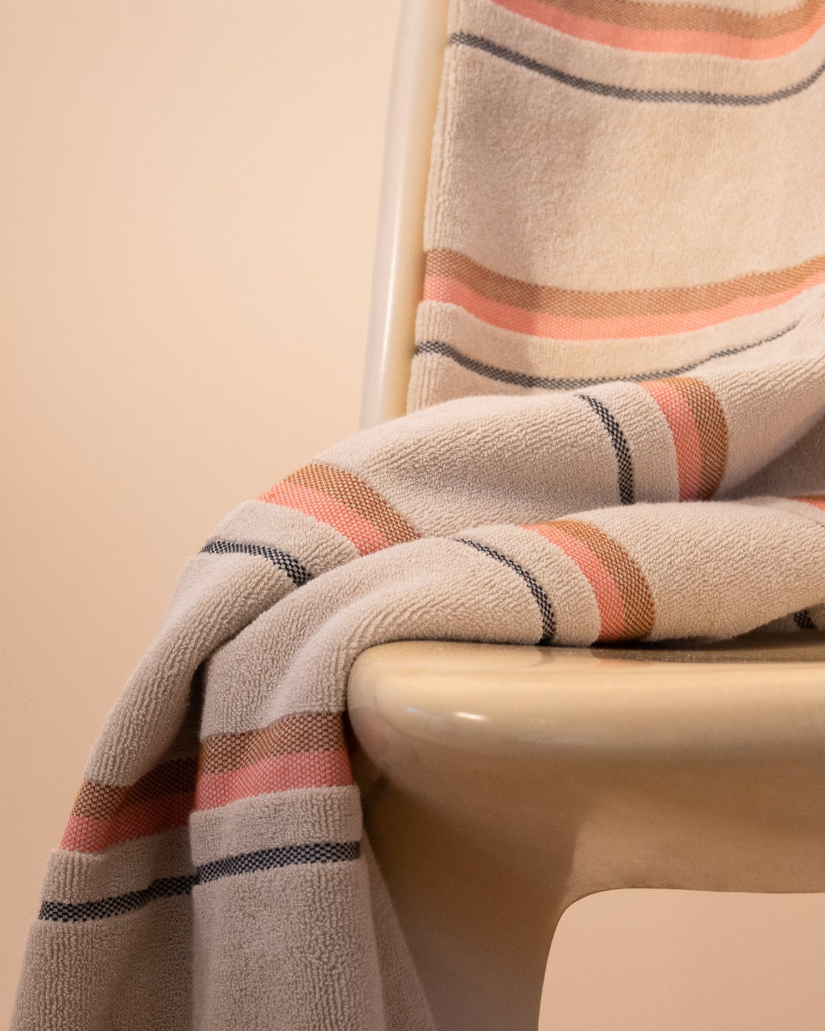 Kobn Sand towel draped on a chair