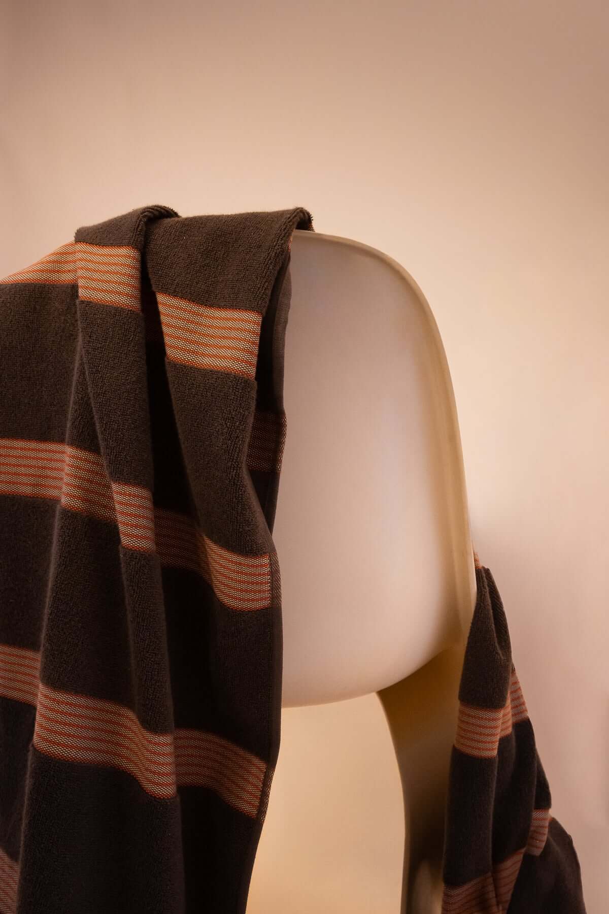 Kobn Umber towel draped on a chair