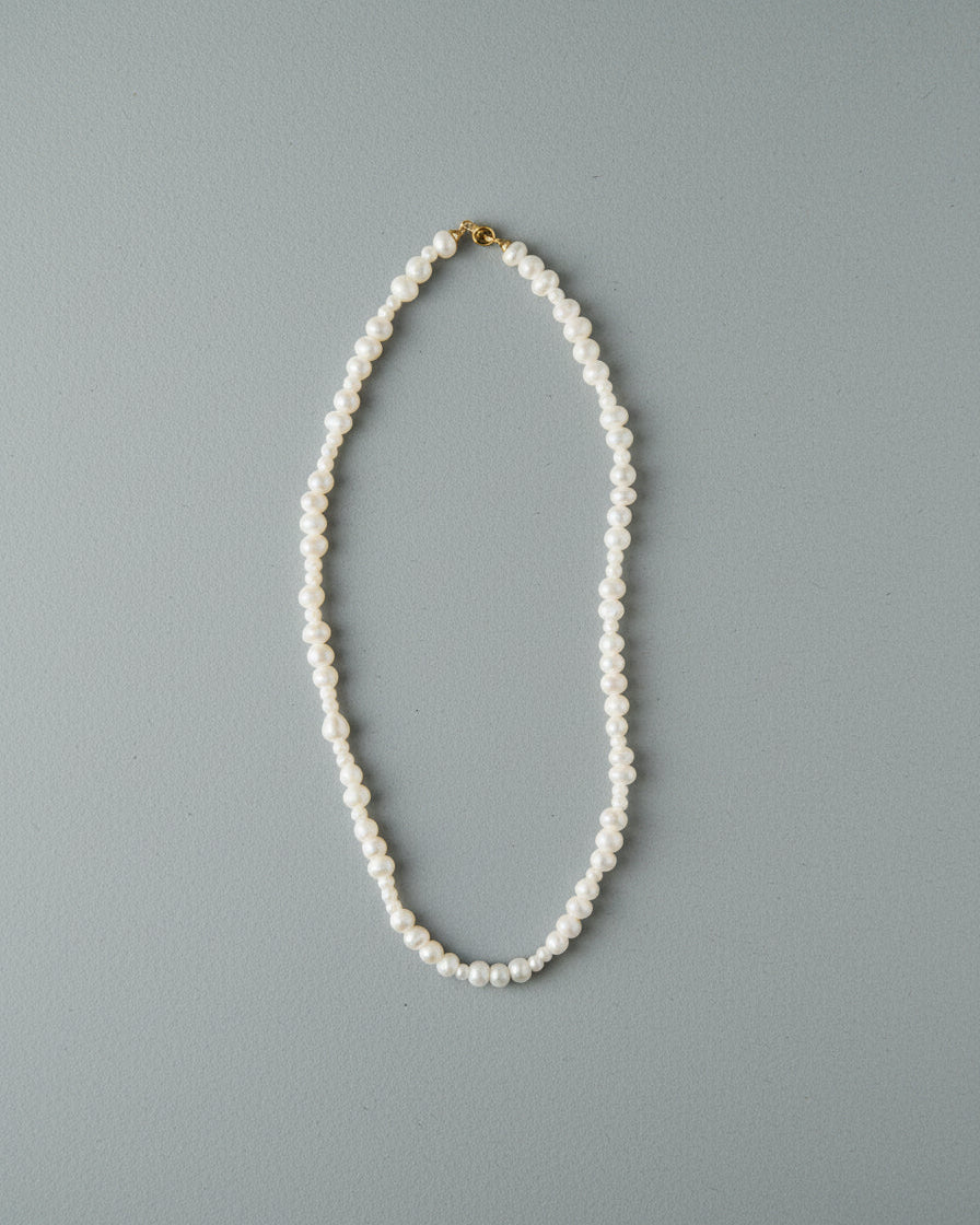Pearl necklace on a gray background