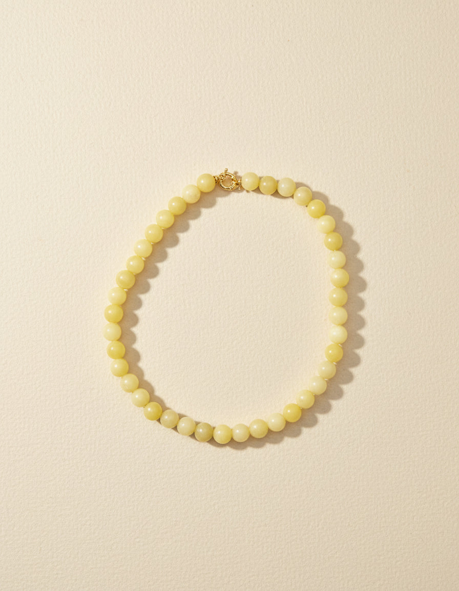 necklace in yellow gemstones on flay lay background
