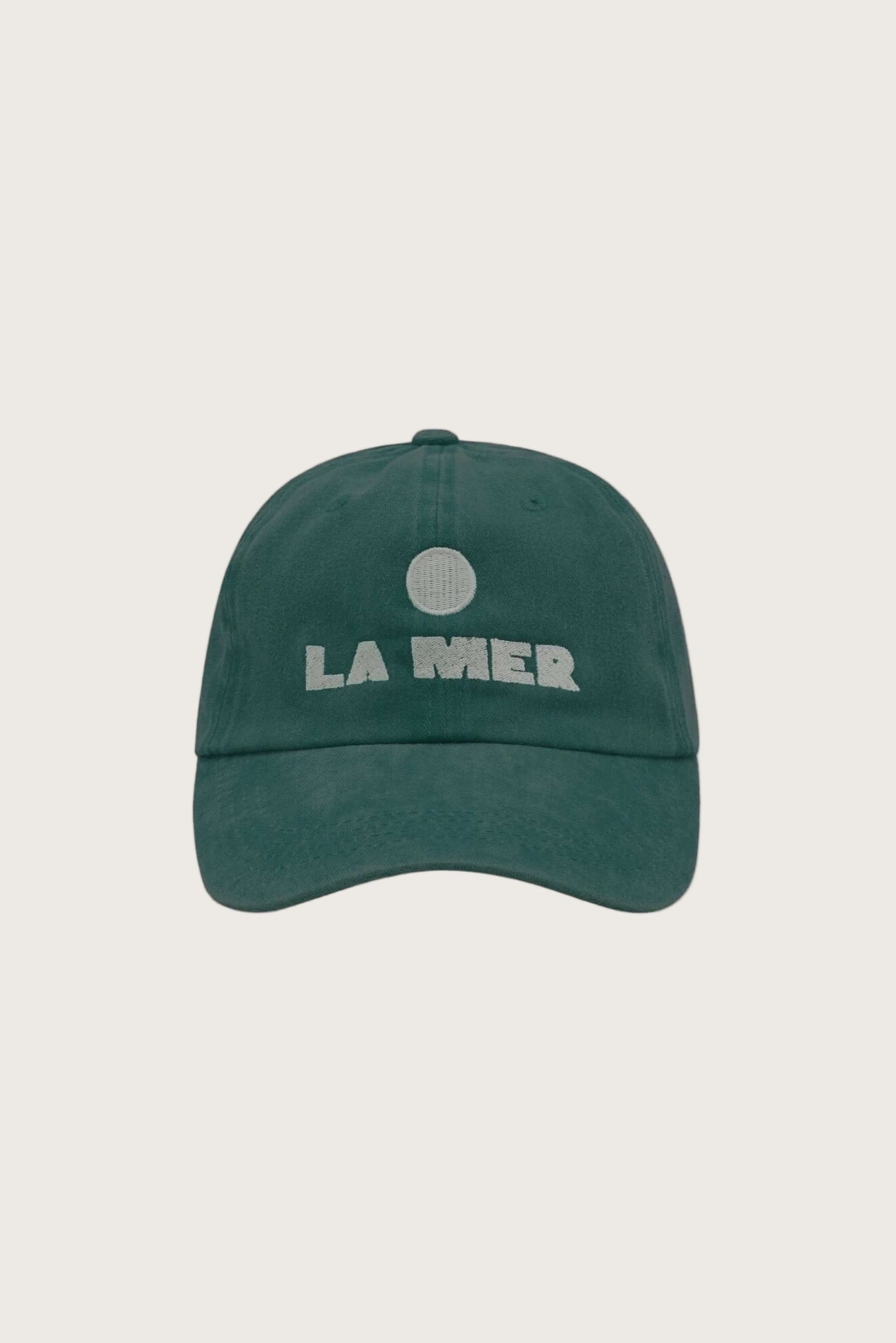 Green cap with 'LA MER' embroidered logo on a white background