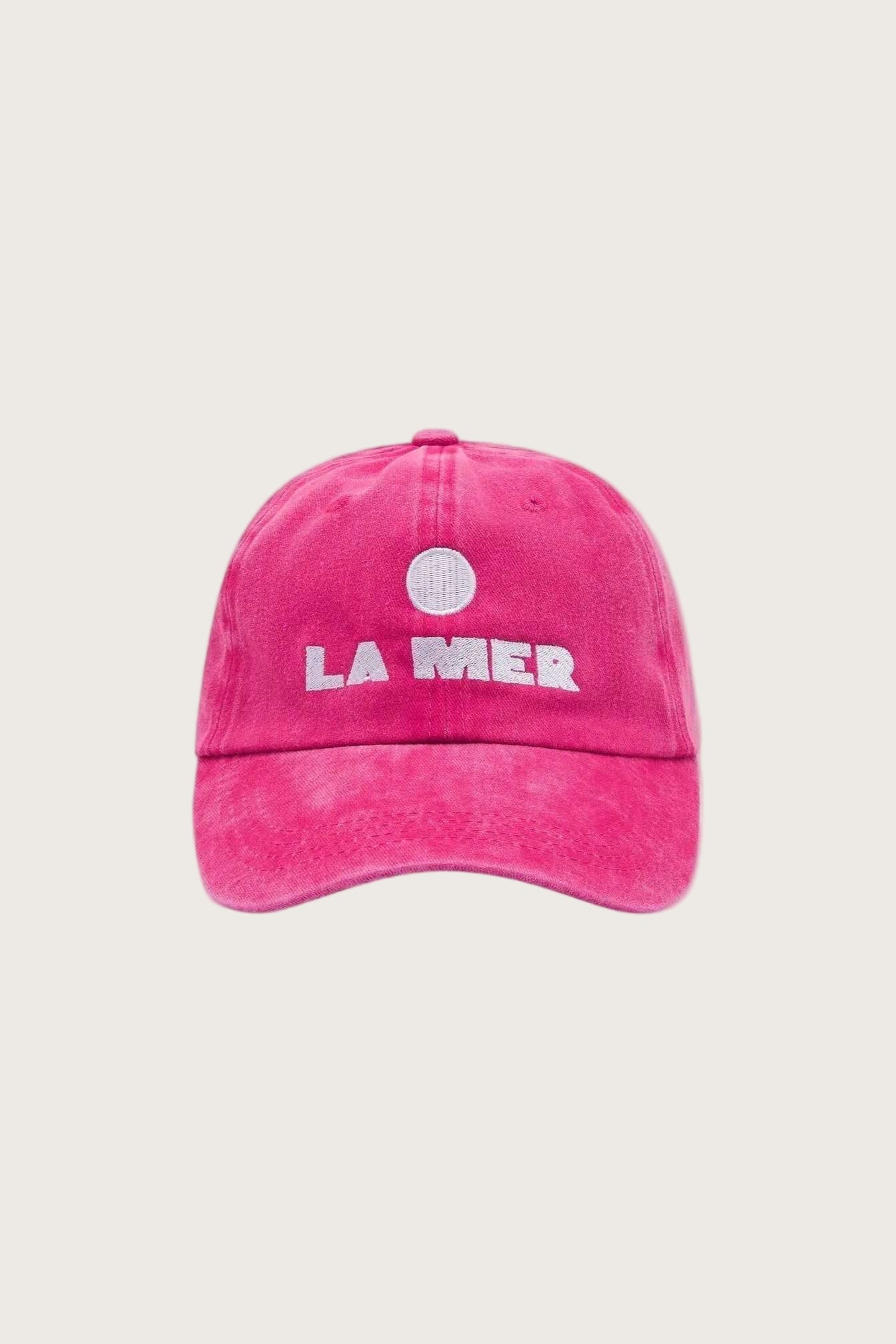 Pink cap with 'LA MER' embroidered logo on a white background