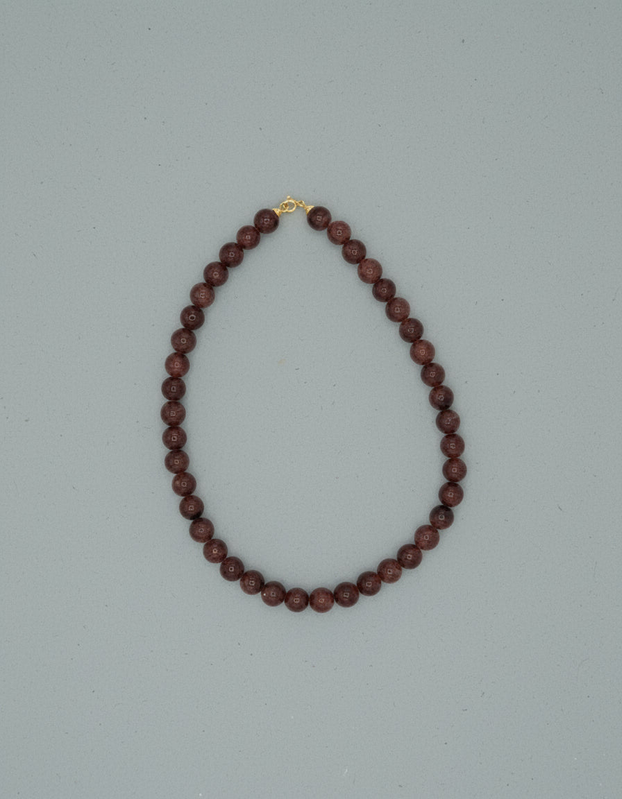 Beaded necklace on a pale blue background