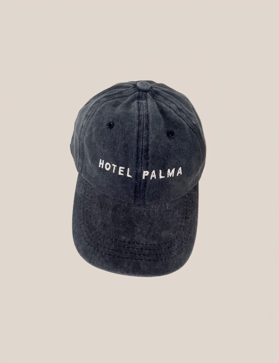 Faded navy cap with 'HOTEL PALMA' embroidered text